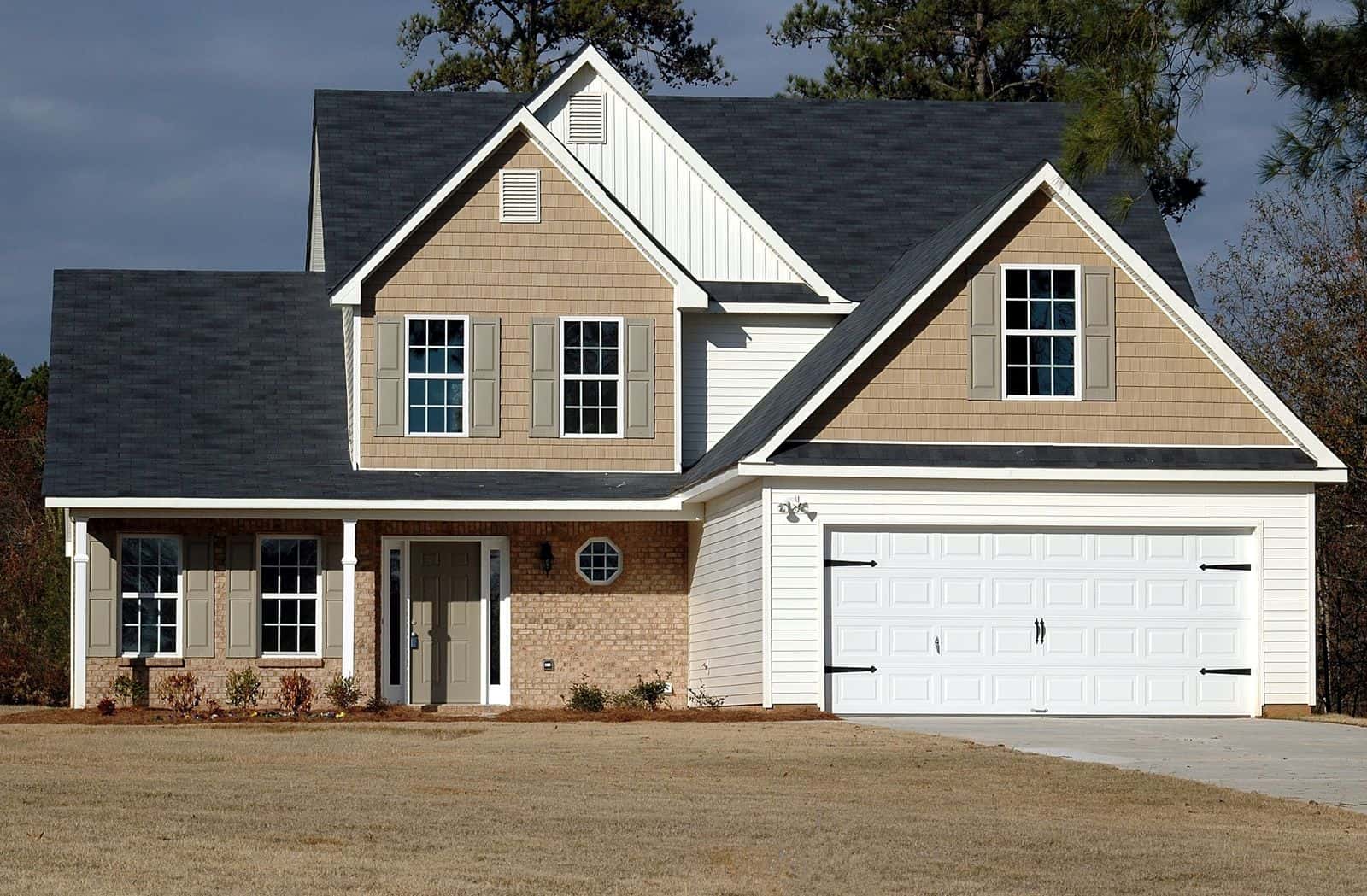 Freshly painted two-story home exterior with crisp trim and new garage door